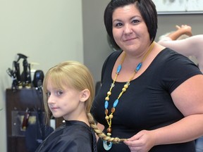 Brooke Melnychuk, 9, from Aylmer has her hair cut at Serene Salon and Spa in Tillsonburg to be made into a wig for her three-year-old cousin, Chloe Rachel Wolfe. CHRIS ABBOTT/TILLSONBURG NEWS