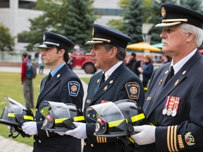 Members of the Ottawa Fire Department carry helmets of fallen firefighters during the 13th annual Ottawa Fallen Firefighter Memorial service adjacent to Ottawa City Hall on Friday September 12, 2014.
Errol McGihon/Ottawa Sun/QMI Agency