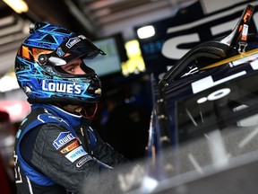 Jimmie Johnson stands in the garage area during practice for the NASCAR Sprint Cup Series MyAFibStory.com 400 at Chicagoland Speedway yesterday. Johnson hasn’t won a race since taking the checkered flag at Michigan in June. (AFP)