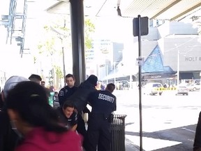 A screen shot shows security guards arresting an individual at City Centre Mall.