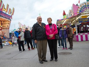 Vi Erickson stands with her husband, Carl, as she enjoys the Western Fair on Friday.  Joined by three other generations, including members of the Brown and Erb families, behind, Erickson says she has seen many changes over the years. She even remembers sneaking into the fair as a child. (CRAIG GLOVER, The London Free Press)