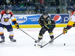 London Knights forward Ryan Valentini, middle, attempts to get the puck through Erie Otters Taylor Raddysh, left, and Patrick Fellows during an exhibition game at Budweiser Gardens. (Free Press file photo)