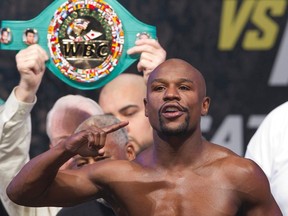 WBC/WBA welterweight champion Floyd Mayweather Jr. of the U.S. poses on the scale during an official weigh-in at the MGM Grand Garden Arena in Las Vegas on September 12, 2014. (REUTERS/Steve Marcus)