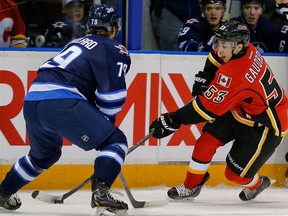 Calgary Flames Johnny Gaudreau skates against Nikolas Brouillard of the  Winnipeg Jets during the 2014 Young Stars Classic Tournament in Penticton, B.C. on Friday. (AL CHAREST/QMI Agency)