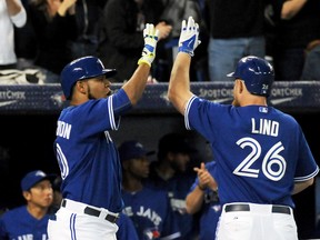 Toronto Blue Jays first baseman Adam Lind celebrates with designated hitter Edwin Encarnacion after hitting a home run against Tampa Bay Rays at the Rogers Centre in Toronto, Sept. 13, 2014. (DAN HAMILTON/USA Today)