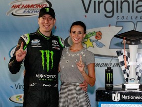 Kyle Busch, driver of the #54 Monster Energy Toyota, left, celebrates with wife Samantha in Victory Lane after winning the NASCAR Nationwide Series Virginia529 College Savings 250 at Richmond International Raceway on Sept. 5, 2014 in Richmond, Virginia. (BRIAN LAWDERMILK/Getty Images/AFP)