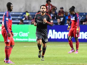 Toronto FC midfielder Dwayne De Rosario makes his way to his teammates after scoring a goal against the Chicago Fire on Saturday night. (USA TODAY Sports)