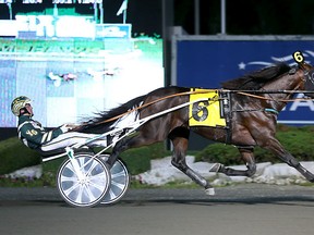 Father Patrick and Yannick Gingras winning the Canadian Trotting Classic Saturday night at Mohawk Racetrack. (Clive Cohen/New Image Media)
