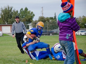 Tyler Riviere, number 25, fought passed a stiff arm to drag the Cobra ball carrier out of bounds at the Senior Mustangs' first home game on Friday. John Stoesser photos/QMI Agency.