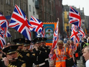Members of the Orange Order march in Edinburgh, Scotland September 13, 2014. About 12,000 Protestant loyalists from Northern Ireland and Scotland marched through central Edinburgh on Saturday in an emotional show of support for keeping Scotland in the United Kingdom. (REUTERS/Russell Cheyne)