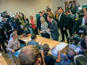 Sweden's Social Democrats Leader Stefan Lofven (C) casts his vote at a polling station during the Swedish general election in Stockholm Sept. 14, 2014. REUTERS/Jonas Ekstromer/TT News Agency