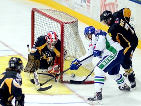 Sudbury Nickel Barons forward Peter Poulin-Roy and Abitibi Eskimos defenceman Brennan Roy battle for a loose puck to the left of Eskimos goalie Chet Tooker during the first period of Saturday night’s NOJHL game at the Jus Jordan Arena. The Nickel Barons posted a 5-4 win over the Eskimos in double overtime.