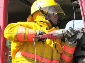Volunteer firefighter Renee Gittens cuts through a transport truck cab during a training exercise on Saturday. NEIL BOWEN/ SARNIA OBSERVER/ QMI AGENCY