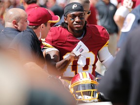 Washington Redskins quarterback Robert Griffin III (10) is carted of the field after being injured against the Jacksonville Jaguars in the first quarter at FedEx Field. (Geoff Burke-USA TODAY Sports)
