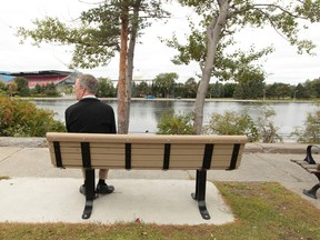 Mayor Jim Watson sits on a park bench over looking Lansdowne Park on Sunday Sept 14, 2014. Watson gathered the media Sunday for a campaign stop announcing his pitch for a sports commissioner from city council if he is re-elected in October. 
Tony Caldwell/Ottawa Sun/QMI Agency