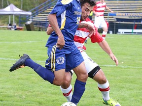 Laurentian Voyageurs Omar Allison fights for the ball with Theodore Lopez de Castilla of the Carleton Ravens during OUA soccer action from the Laurentian Field on Sunday afternoon.