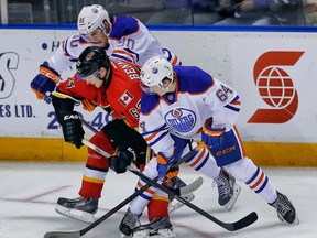 Calgary Flames Sam Bennett battles for the puck against  Graeme Craig and Vladimir Tkachev of the Edmonton Oilers during the 2014 Young Stars Classic Tournament in Penticton, B.C. on Saturday September 13, 2014. Al Charest/Calgary Sun/QMI Agency