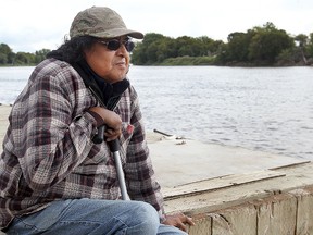 Dragmaster Percy Ningewance views the Red River at the Alexander Docks in Winnipeg, Man. Sunday September 14, 2014. Ningewance will assist in the dragging of the Red in hopes of finding answers to some missing and murdered aboriginal women cases. (Brian Donogh/Winnipeg Sun/QMI Agency)