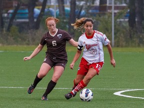 Sera Trunzo (right) of the Winnipeg Wesmen, tries to get away from Manitoba Bisons defender Robin Kastner during Canada West soccer action on the weekend. (Shawn Coates/for the Winnipeg Sun)