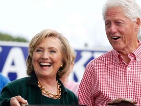 Former U.S. Secretary of State Hillary Clinton and her husband former U.S. President Bill Clinton hold up some steaks at the 37th Harkin Steak Fry in Indianola, Iowa, September 14, 2014. REUTERS/Jim Young