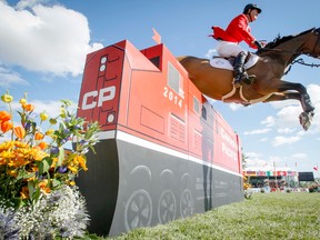Ian Millar, of Perth, Ont., rides his mount, Dixson to the half-million-dollar victory in Sunday’s CP International Grand Prix at Spruce Meadows. The Canadian triumph wrapped up what was a roller-coaster week at the Masters and an incredible performance by Canadians to end the Spruce Meadows competitive season. Photo by Lyle Aspinall/Calgary Sun