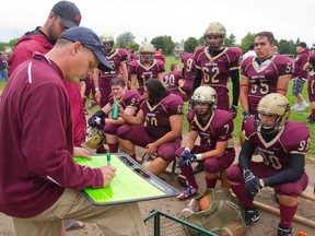 Broncos head coach Todd MacKay diagrams a play during an exhibition game against Oakridge at Banting last week. (MIKE HENSEN, The London Free Press)