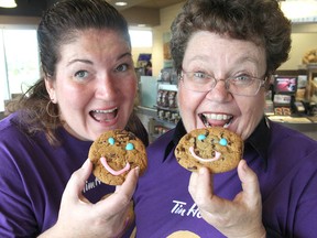 Sherri Agnew, left, chief executive officer of J.E. Agnew Food Services, and Denise Cumming, executive director of the University Hospitals Kingston Foundation, promote the annual Smile cookie campaign at local Tim Hortons outlets. MON., SEPT. 15, 2014 KINGSTON, ONT. MICHAEL LEA\THE WHIG STANDARD\QMI AGENCY