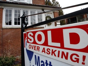 A sign is displayed in front of a home in Toronto in this December 15, 2009 file photo. (REUTERS/Mike Cassese/Files)