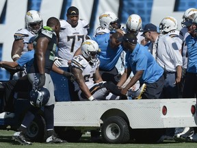 Running back Ryan Mathews #24 of the San Diego Chargers is attended to by medical personnel while playing the Seattle Seahawks at Qualcomm Stadium on September 14, 2014 in San Diego, California.  (Donald Miralle/Getty Images/AFP)