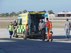 A migrant is helped by an Armed Forces of Malta (AFM) airman to a waiting ambulance after being brought to Malta by helicopter at the Air Wing base outside Valletta in this handout taken September 14, 2014 and released September 15, 2014 courtesy of the Armed Forces of Malta. Some 500 migrants are believed to have died in the Mediterranean after traffickers rammed their boat off Malta's coast last week, the International Organisation for Migration said on Monday. (REUTERS/Justin Gatt/Armed Forces Malta Press Office/Handout via Reuters)