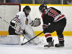 Mitchell Hawks’ goalie Clay Carter (30) stops Walkerton Hawks’ Calvin Penney (16) at point blank range during second period action of their Western Jr. C hockey league game Sunday, Sept. 14. Walkerton dumped the hometown Hawks, 7-1. ANDY BADER/MITCHELL ADVOCATE