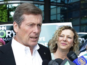 John Tory speaks at press conference where Councillor Jaye Robinson (background) endorsed his mayoral candidacy in Toronto on Monday, September 15, 2014. (Craig Robertson/Toronto Sun)