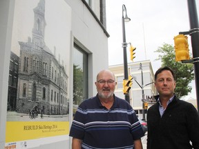Sarnia Heritage Committee members Wayne Wager and Gregory Ross stand beside a mural of Sarnia's city hall, as it was when it stood in the early 1900s where Limbo Lounge is now. The poster is part of a Rebuild Sarnia Heritage campaign the committee launched this year, aimed at increasing historical literacy and engagement in downtown Sarnia. TYLER KULA/ THE OBSERVER/ QMI AGENCY