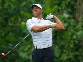 Tiger Woods of the U.S. grimaces after hitting his tee shot on the seventh hole during the second round of the 2014 PGA Championship at Valhalla Golf Club on August 8, 2014. (REUTERS/Brian Snyder)