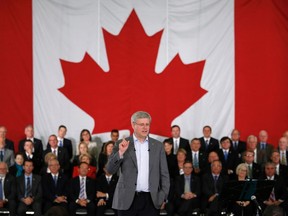 Prime Minister Stephen Harper delivers a speech to members of his caucus and supporters in Ottawa September 15, 2014. REUTERS/Chris Wattie