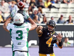 Tiger-Cats quarterback Zach Collaros throws the ball past a jumping Roughriders defensive back Macho Harris during CFL action on Sunday at Tim Hortons Field in Hamilton. The Tiger-Cats went on to pound Saskatchewan 28-3. (Dave Sandford/Getty Images)