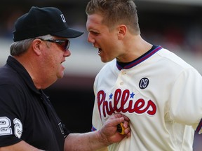 Jonathan Papelbon of the Philadelphia Phillies argues with umpire Joe West after Papelbon was ejected from the game after making an obscene gesture while leaving the field after the final out in the ninth inning against the Miami Marlins in a game at Citizens Bank Park on September 14, 2014. (Rich Schultz/Getty Images/AFP)