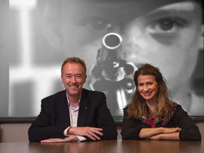 Dr. Adrian Owen and Dr. Lorina Naci of  Western University's  Brain and Mind Institute  pose in front of a scene from an an episode of Alfred Hitchcock Presents in London, Ontario on Sept. 15, 2014.  (DEREK RUTTAN/QMI AGENCY)