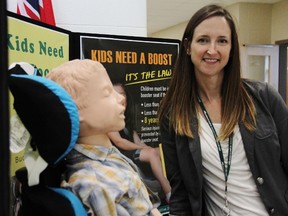 Health Unit nurse Meagan Melling with a demonstration doll used to show effects of booster seat use in vehicles for kids. A safety coalition formed by various London and Middlesex partners is tackling statistics that say many kids that should be using booster seats while in a vehicle are not. ELENA MAYSTRUK/AGE DISPATCH/QMI AGENCY