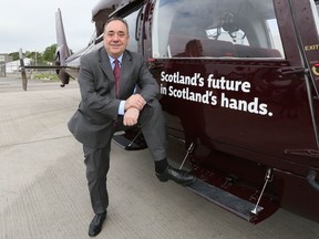 First Minister of Scotland Alex Salmond poses before boarding a flight in his campaign helicopter, Aberdeen, September 16, 2014. The referendum on Scottish independence will take place on September 18, when Scotland will vote whether or not to end the 307-year-old union with the rest of the United Kingdom. (REUTERS/Paul Hackett)