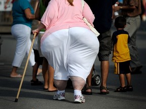 A file photo taken on August 19, 2009 shows an overweight woman walking at the 61st Montgomery County Agricultural Fair in Gaithersburg, Maryland.