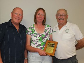 BMO area manager Gerry Lowe presents Doug and Judy Krall with the BMO Family Farm Award. The presentation was made at the 2014 Lambton County Plowing Match awards banquet held in Warwick Village.