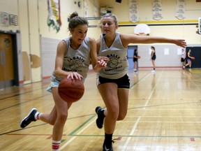 Camille Pearson, left, tries to drive by teammate Madelen Fellows at practice Tuesday as the La Salle Black Knights senior girls basketball team prepares for the Kingston Area Secondary Schools Athletic Association season. (IAN MACALPINE/THE WHIG-STANDARD)