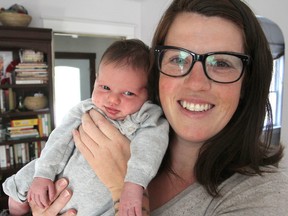 Natalie George holds her new daughter Sadie, the first baby to be born via a water birth at Kingston General Hospital. Two other children were born the same way but at home. (Michael Lea/The Whig-Standard)