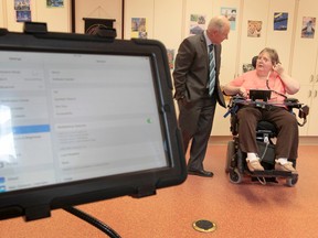 Bruyere's Saint-Vincent Hospital president Bernie Blais talks to hospital patient Molly Knox on Tuesday Sept 16, 2014. A team at the hospital is adapting technology to help severely disabled patients communicate and maintain some independence. Patient Molly Knox uses the new technology which allows her to control her computer tablet.  
Tony Caldwell/Ottawa Sun/QMI Agency