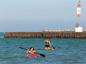 Lisa Dutot of Brucefield paddles a kayak while Corry Scholdice uses her paddleboard to get a workout in Lake Huron off the beach in Bayfield. The two women were enjoying a day off. (MIKE HENSEN, The London Free Press)