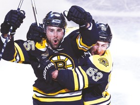Will rugged defenceman Johnny Boychuk (left) be a casualty of the Boston Bruins’ salary-cap woes? (USA TODAY SPORTS)