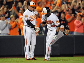 Baltimore Orioles third baseman Jimmy Paredes is congratulated by third base coach Bobby Dickerson after hitting a solo home run in the second inning against the Toronto Blue Jays at Oriole Park at Camden Yards on September 16, 2014. (Joy R. Absalon/USA TODAY Sports)
