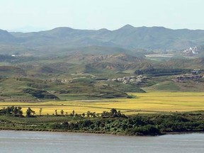 A North Korean village is seen across the Imjin River in this picture taken from an observation post in the south of the demilitarized zone in Paju, north of Seoul September 16, 2013.    REUTERS/Han Jae-ho/News1