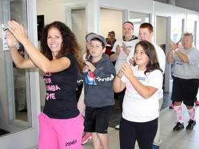 Ben Leeson/The Sudbury Star/QMI Agency
Christina Chicoine from Zumba Vibe leads students from Churchill Public School in a Zumba dance fitness demonstration during the CIBC Run for the Cure media launch at Cambrian Ford in Sudbury on Tuesday. The Vibe Tribe team will be dancing for five kilometres of this year's run, on Oct. 5, and is inviting other participants to join them.